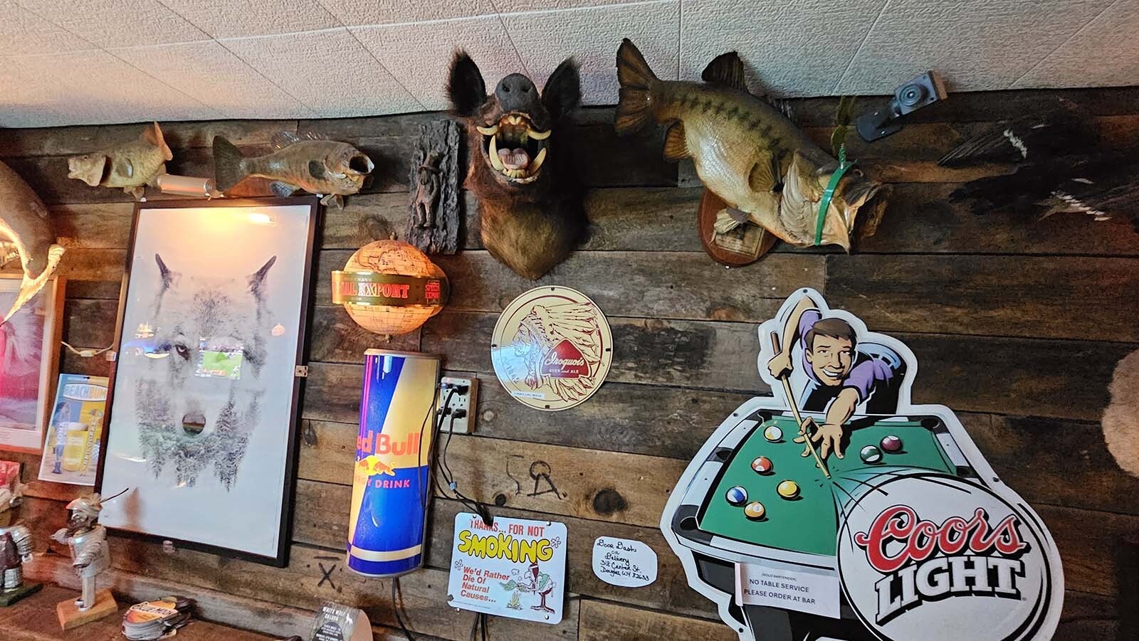 One of the busy walls at the White Wolf Saloon in Douglas.