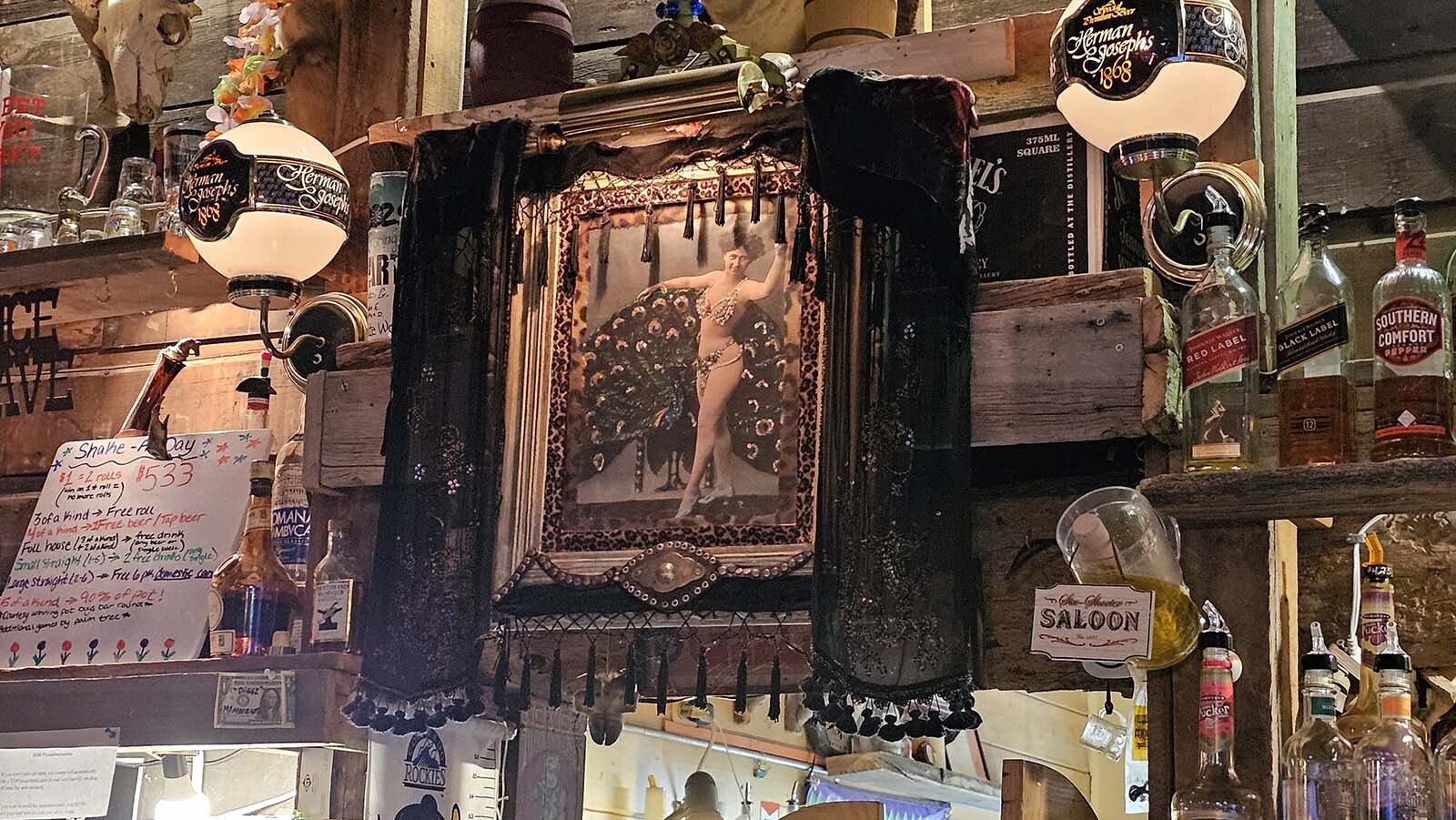 A fancy photo of a woman with a peacock  at the White Wolf Saloon in Douglas.