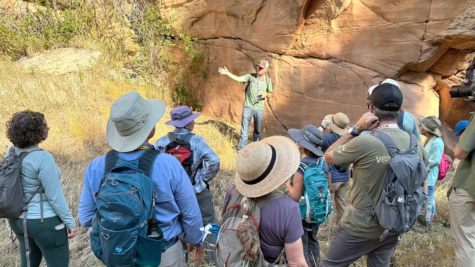 Lucas Keeler, a BLM petroleum engineering technician, explains the significance of the petroglyph panels at Whoopup Canyon in Crook County.