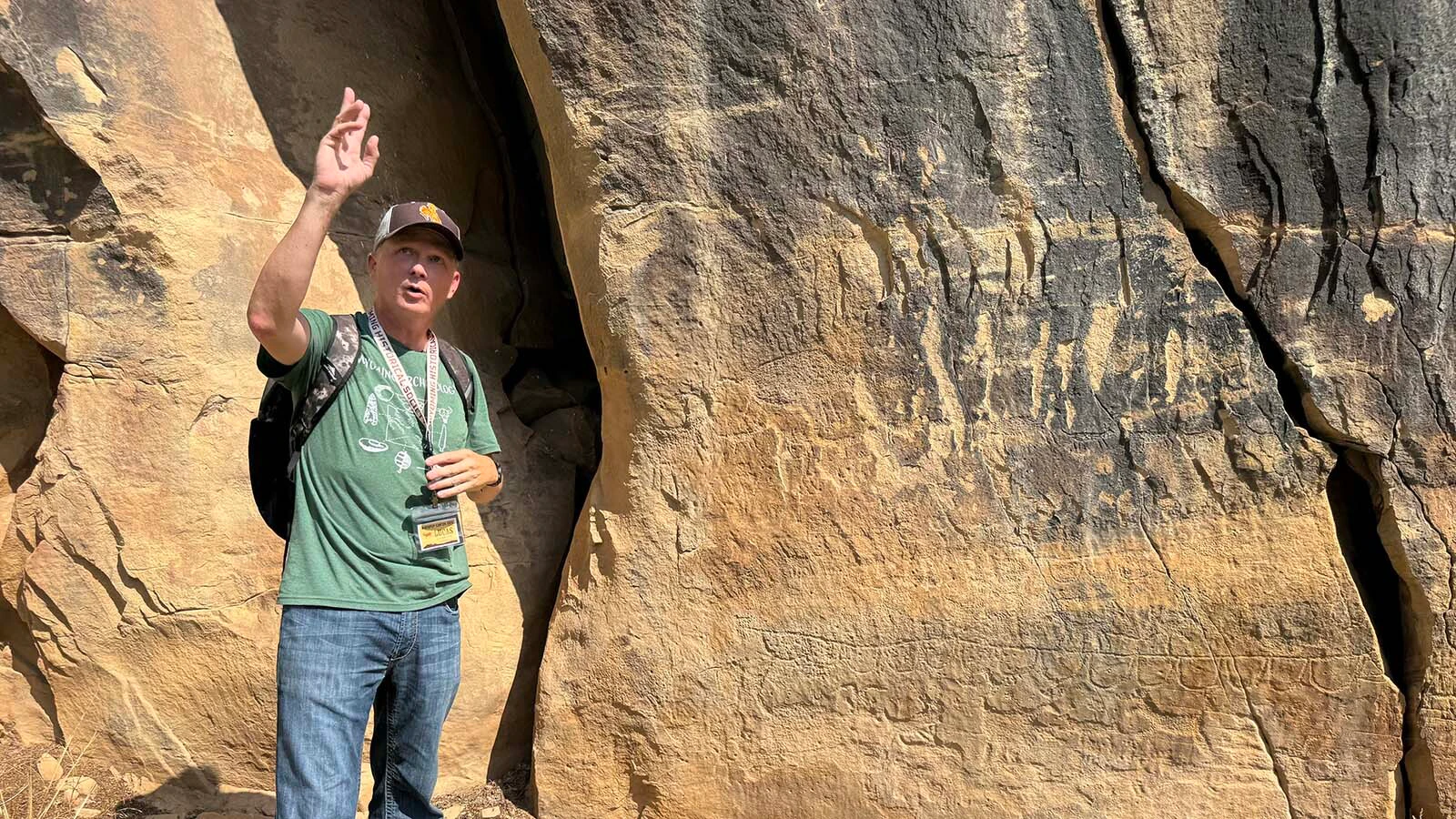 Lucas Keeler, a BLM petroleum engineering technician, explains the significance of the petroglyph panels at Whoopup Canyon in Crook County. 