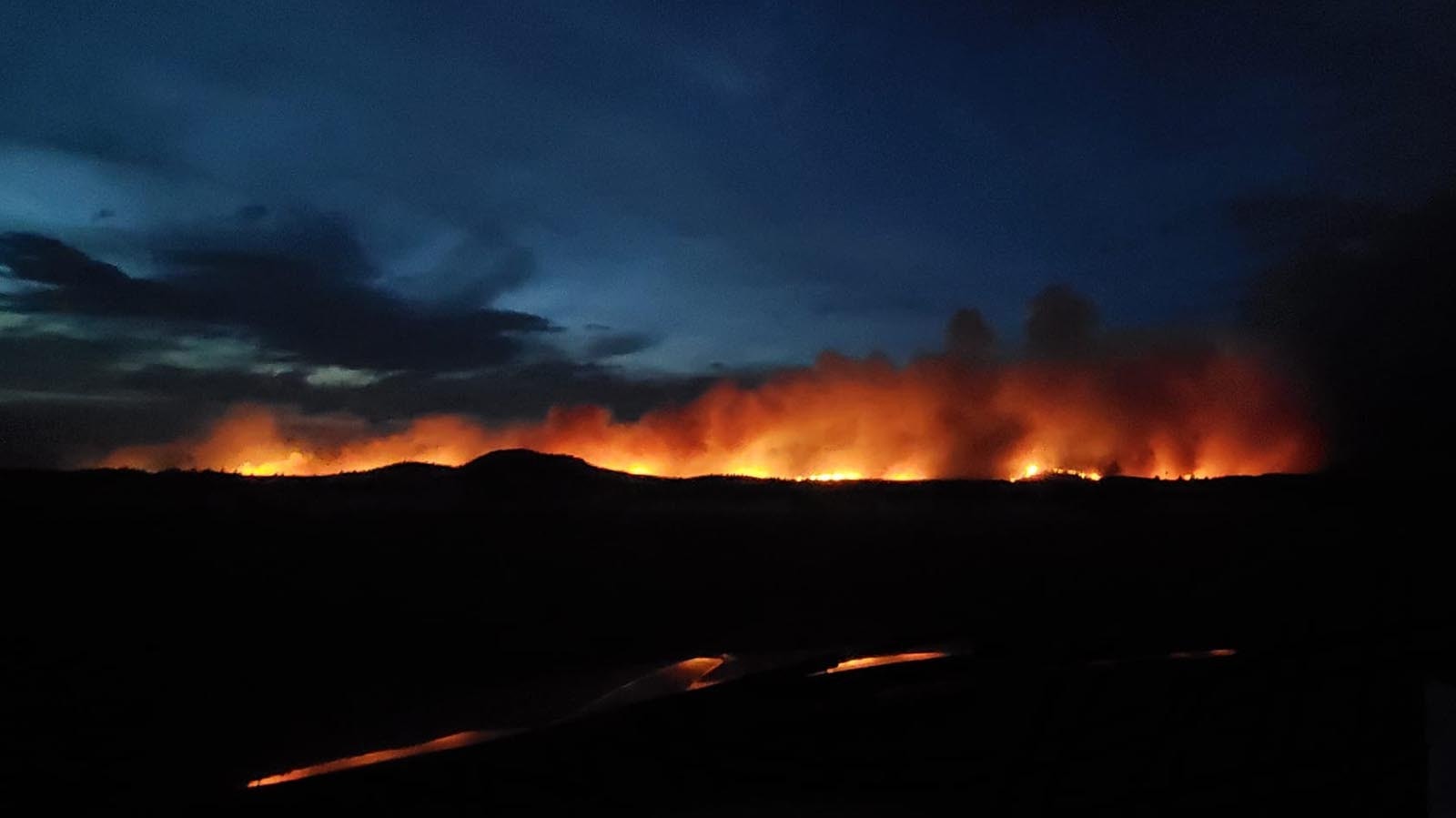 The combine Pleasant Valley/Hartville fires glow ominously overnight Tuesday.