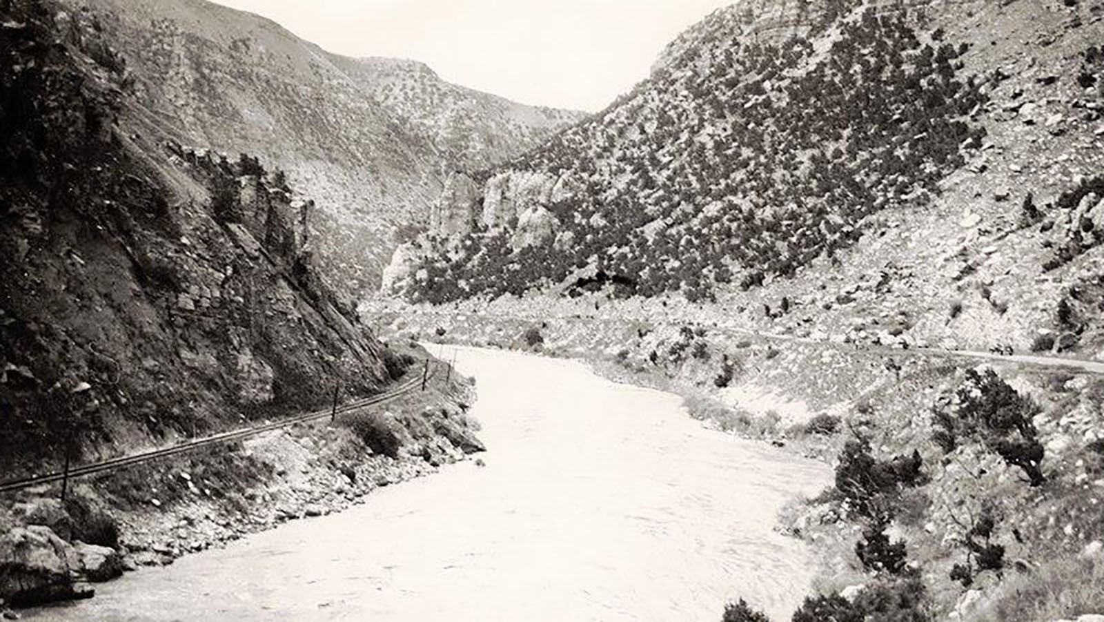 View of the Yellowstone Highway through Wind River Canyon showing road and early railroad in an undated photo.