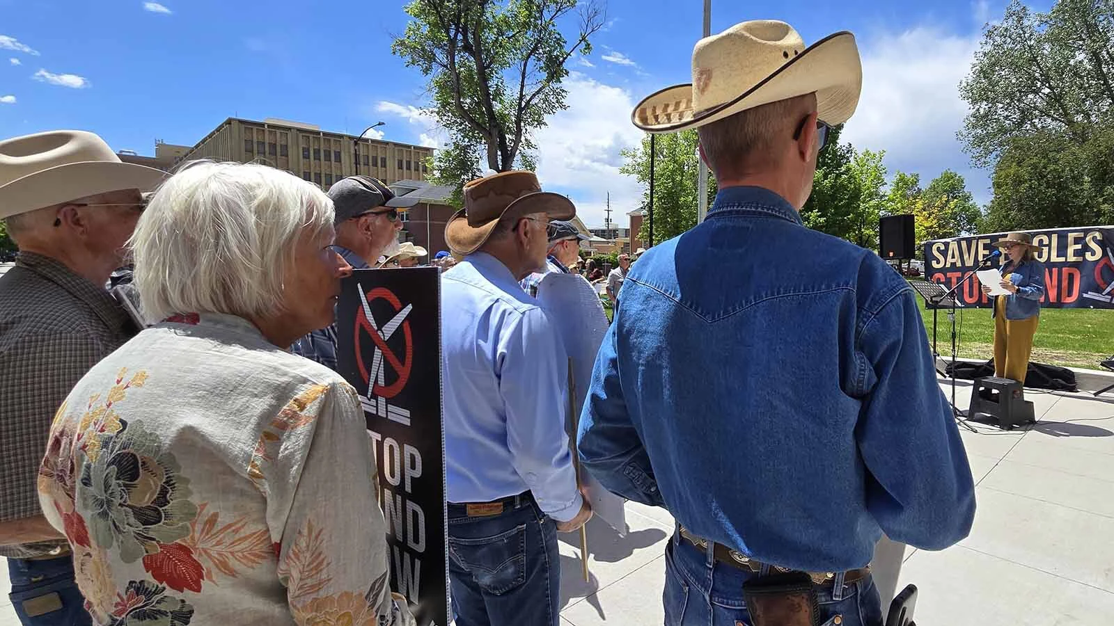 Wendy Volk, right, was among a crowd that included ranching families who are calling for more scrutiny of wind projects in Wyoming. They said a 200-mile wind wall has sprung up in southeastern Wyoming that threatens wildlife, their way of life, and the legacy of future generations.