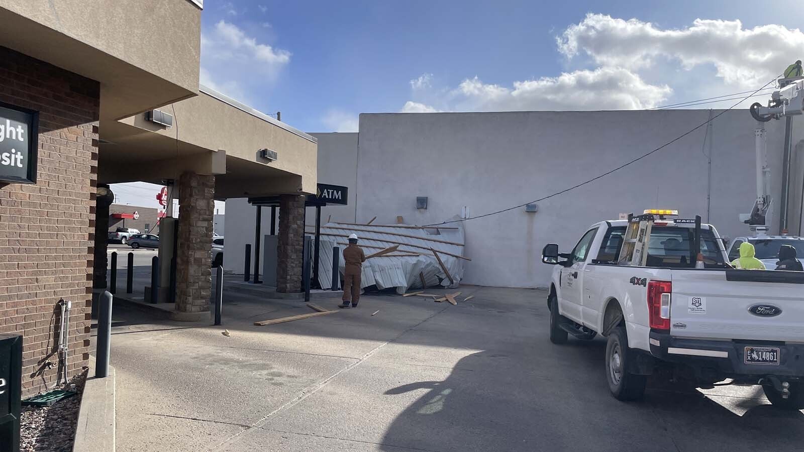 Friday's hurricane-force winds tore part of the roof off a building in Torrington, planting in the drive-thru of a bank across the street.