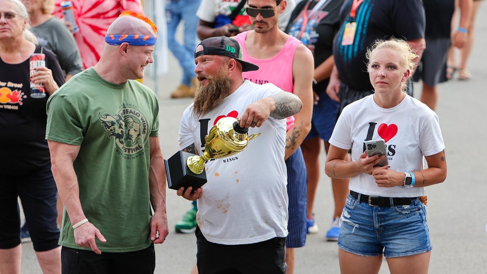 Trent Weitzel is proud to show off the Best Hot Traditional Wing Sauce trophy.