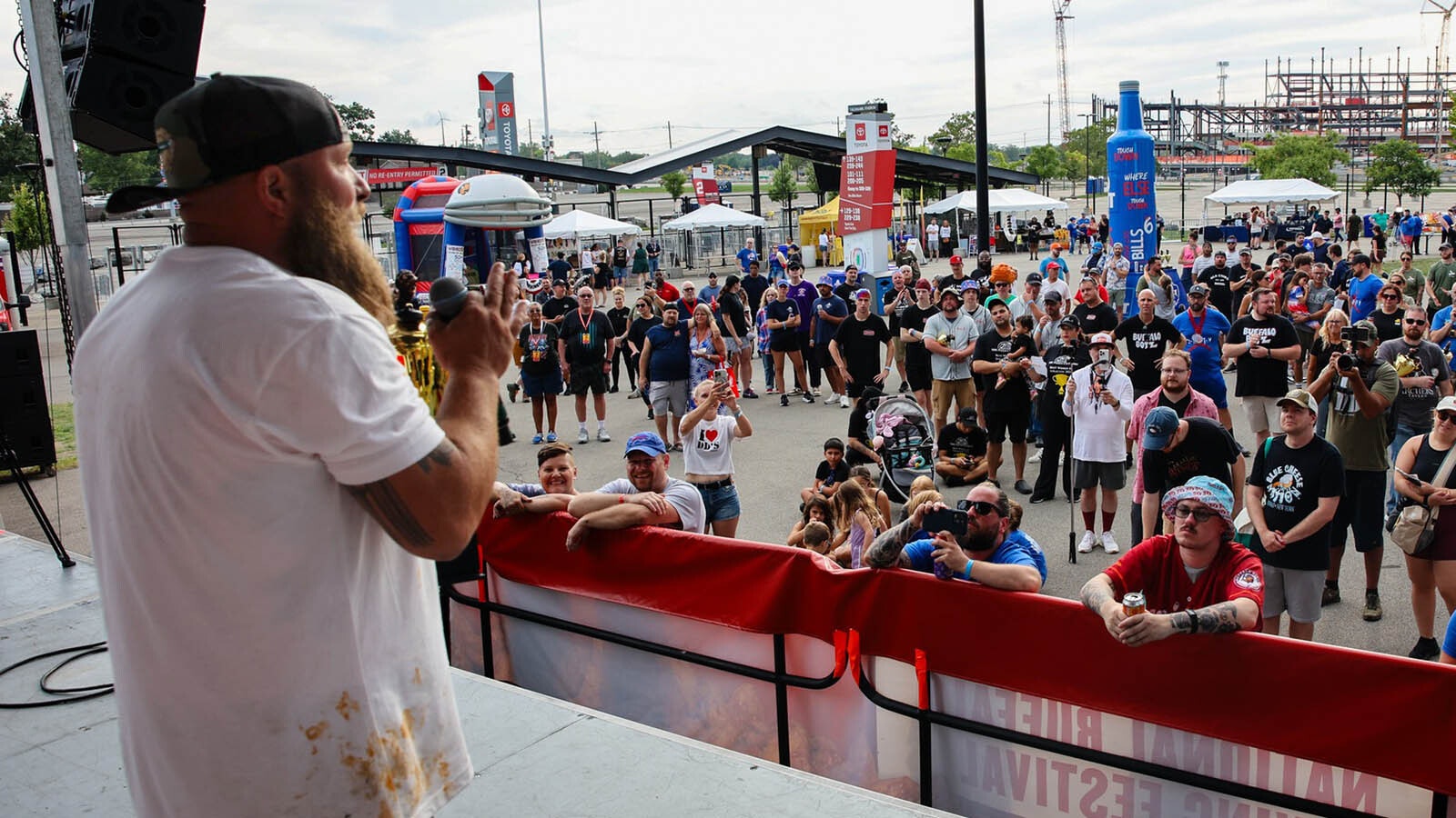 Trent Weitzel talks to the crown after winning first place for Best Hot Tranditional Wing Sauce.