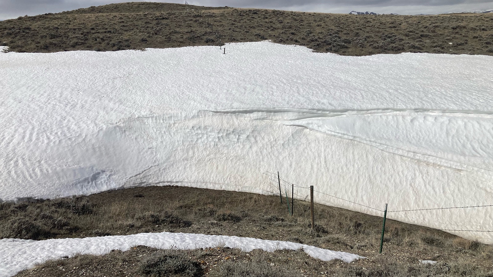 Fences on the Sun family ranch west of Casper — like many across Wyoming — have been hammered by huge snowdrifts this winter.