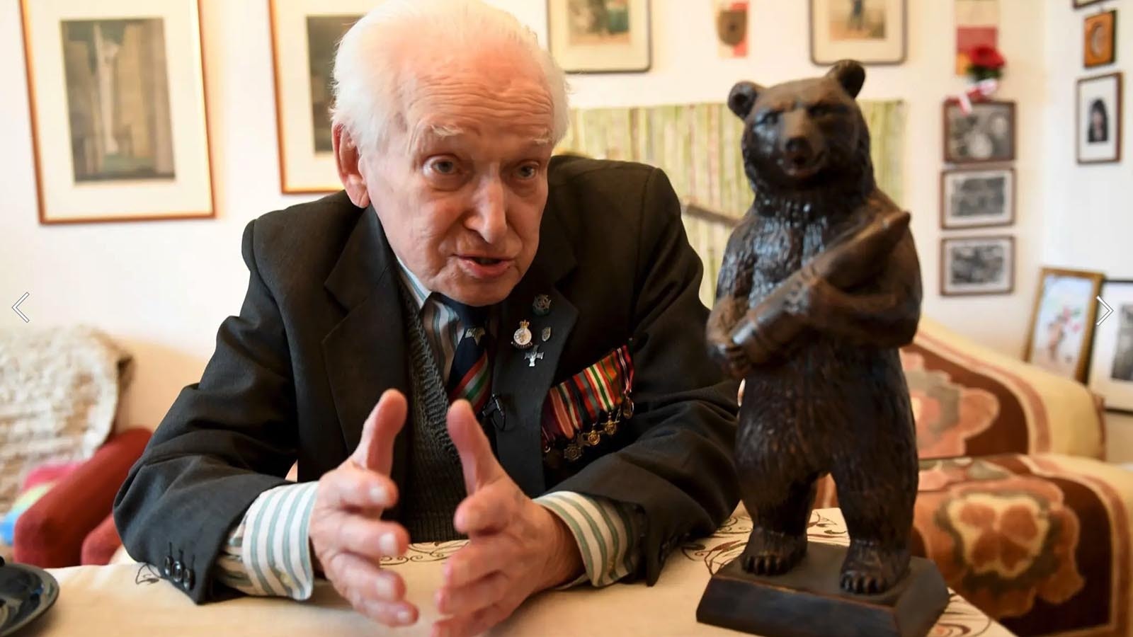 93-year-old former Polish soldier Wojciech Narebski sits next to a statue of brown bear Wojtek, who was his fellow Polish soldier during World War II .