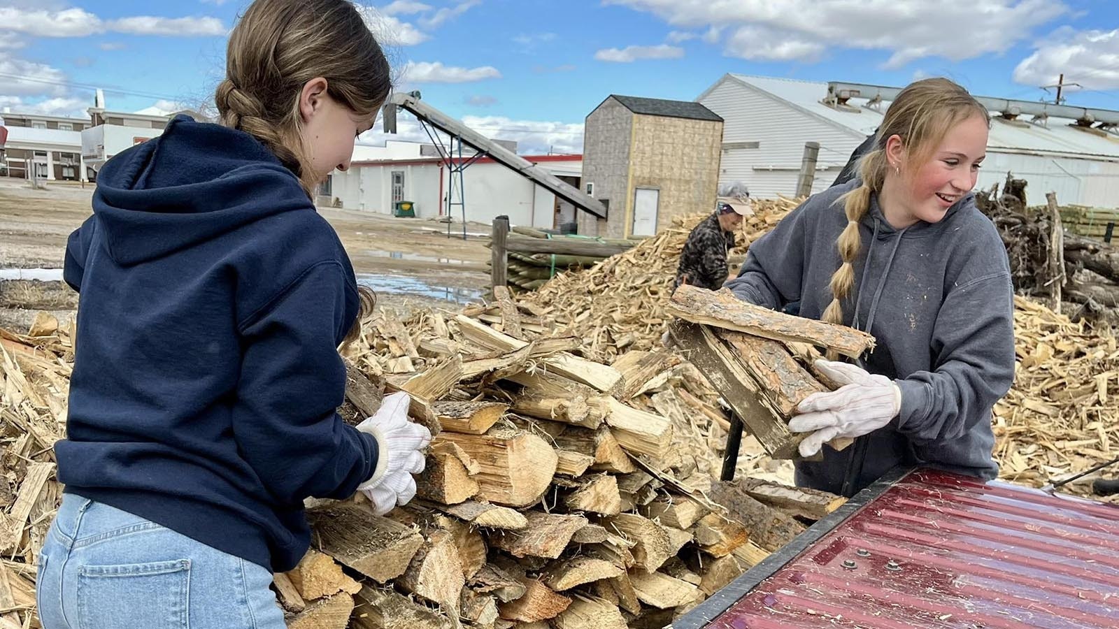 Volunteers load a pickup during one of the wood bank’s Tuesday giveaways.