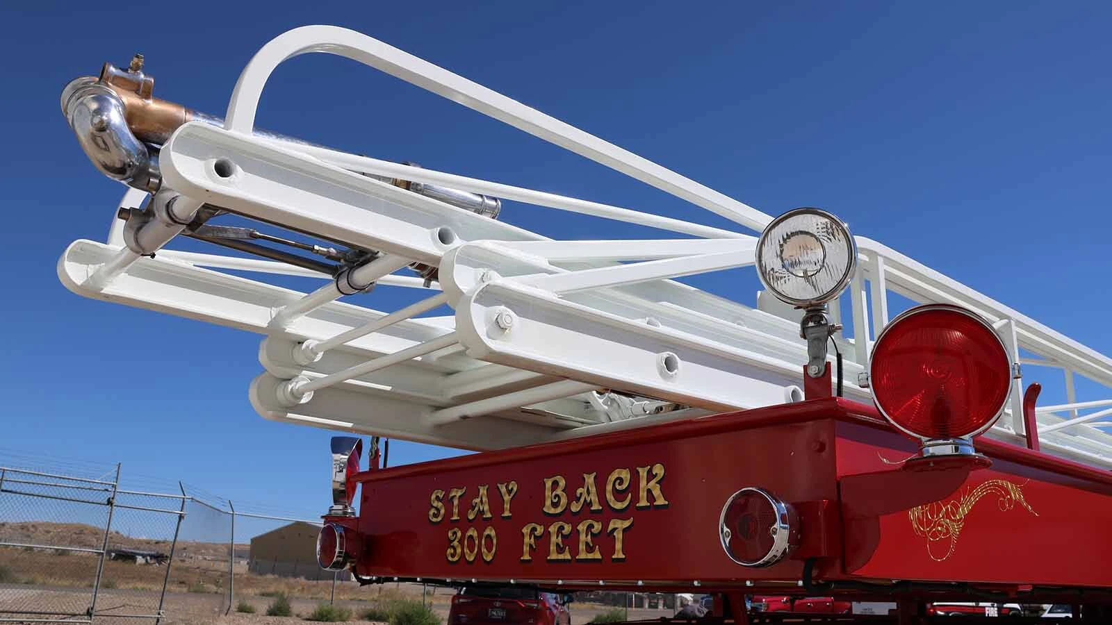 The rear of the 65-foot ladder with the hose connection at the top. 