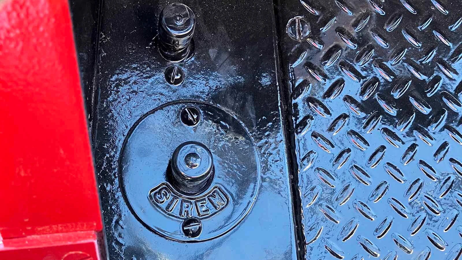 A pedal on the floor is used to operate the truck’s siren.