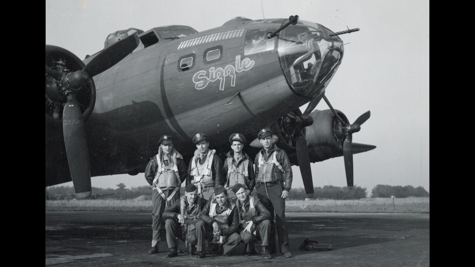 Members of the B-17 “Sizzle” crew pose with their bomber. Pilot Bill Hines is standing at right.