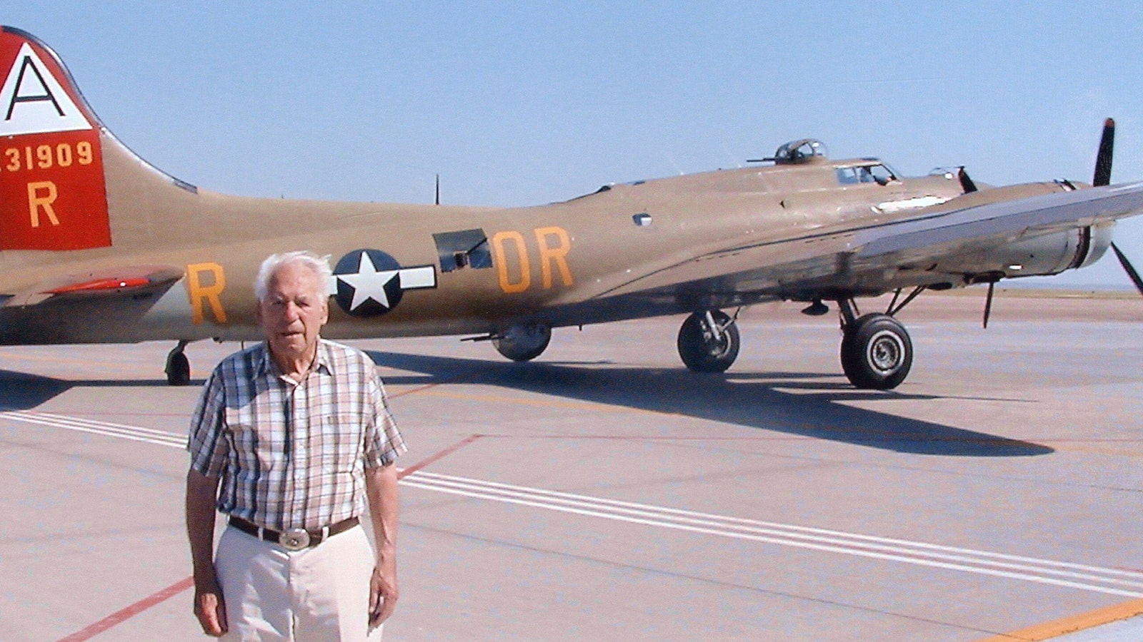 E.A. “Bill” Sikes poses with a bomber during his later years.
