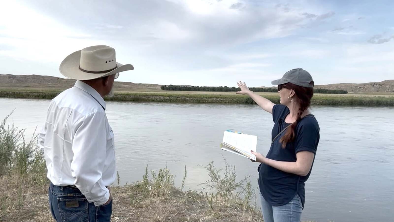 Janelle Molony and rancher Larry Cundall map out Sarah Rousseau's journey near Orin, Wyoming.