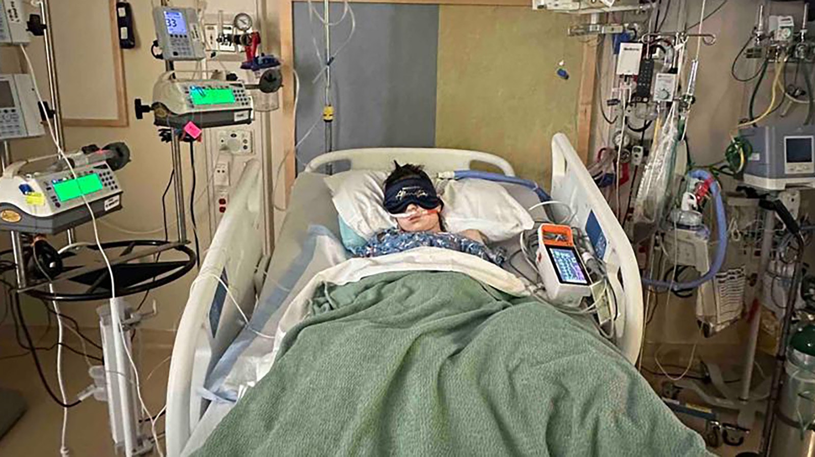 Wyatt Morgan, 8, in a hospital bed as his body fights a serious condition that had fluid filling his lungs and putting pressure on his heart.