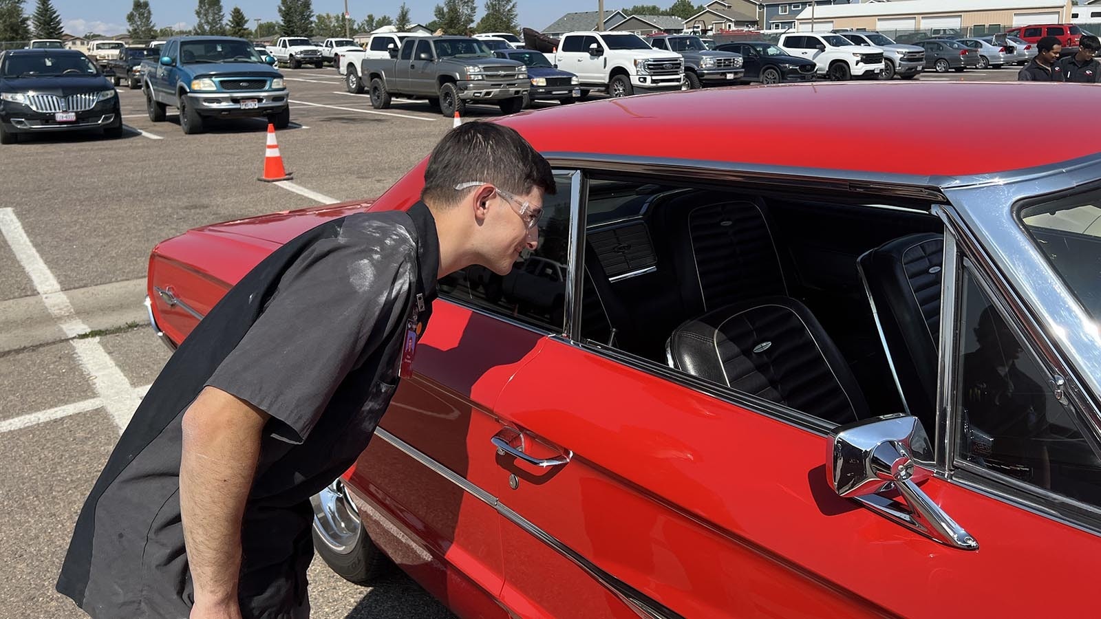 Ethan Shervanick, a WyoTech student who specializes in automotive upholstery, eyes the interior of a 1964 Ford Galaxie 500. The car was on display at the Goodguys Rod & Custom Association car show on the WyoTech campus in Laramie on Thursday.