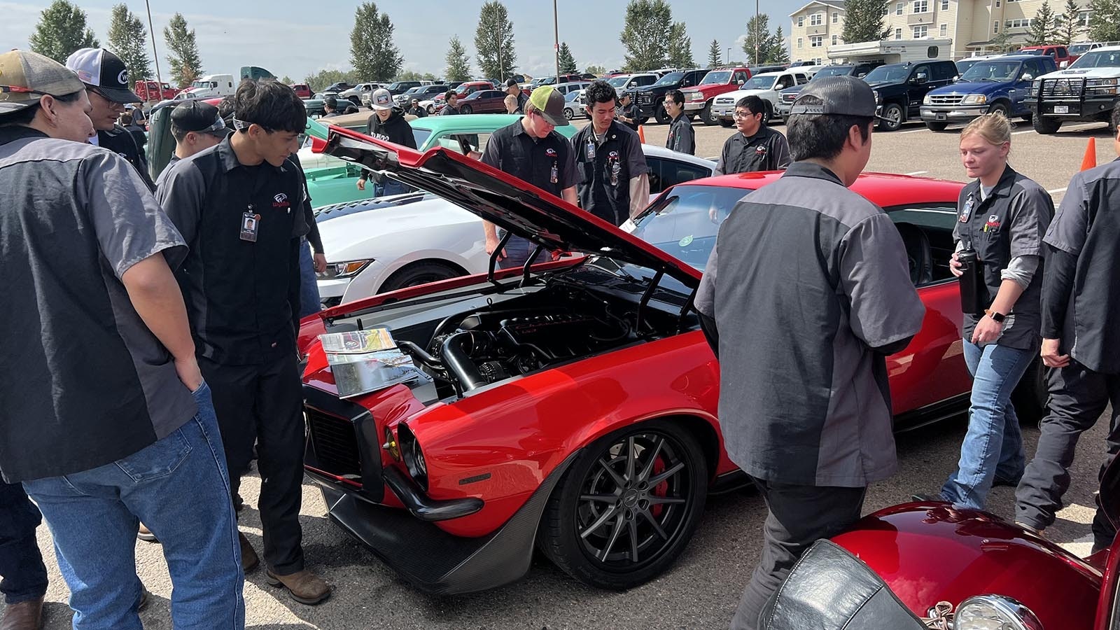 WyoTech students crowd around custom-built hotrods at the Goodguys Rod & Custom Association car show on the WyoTech campus in Laramie on Thursday.