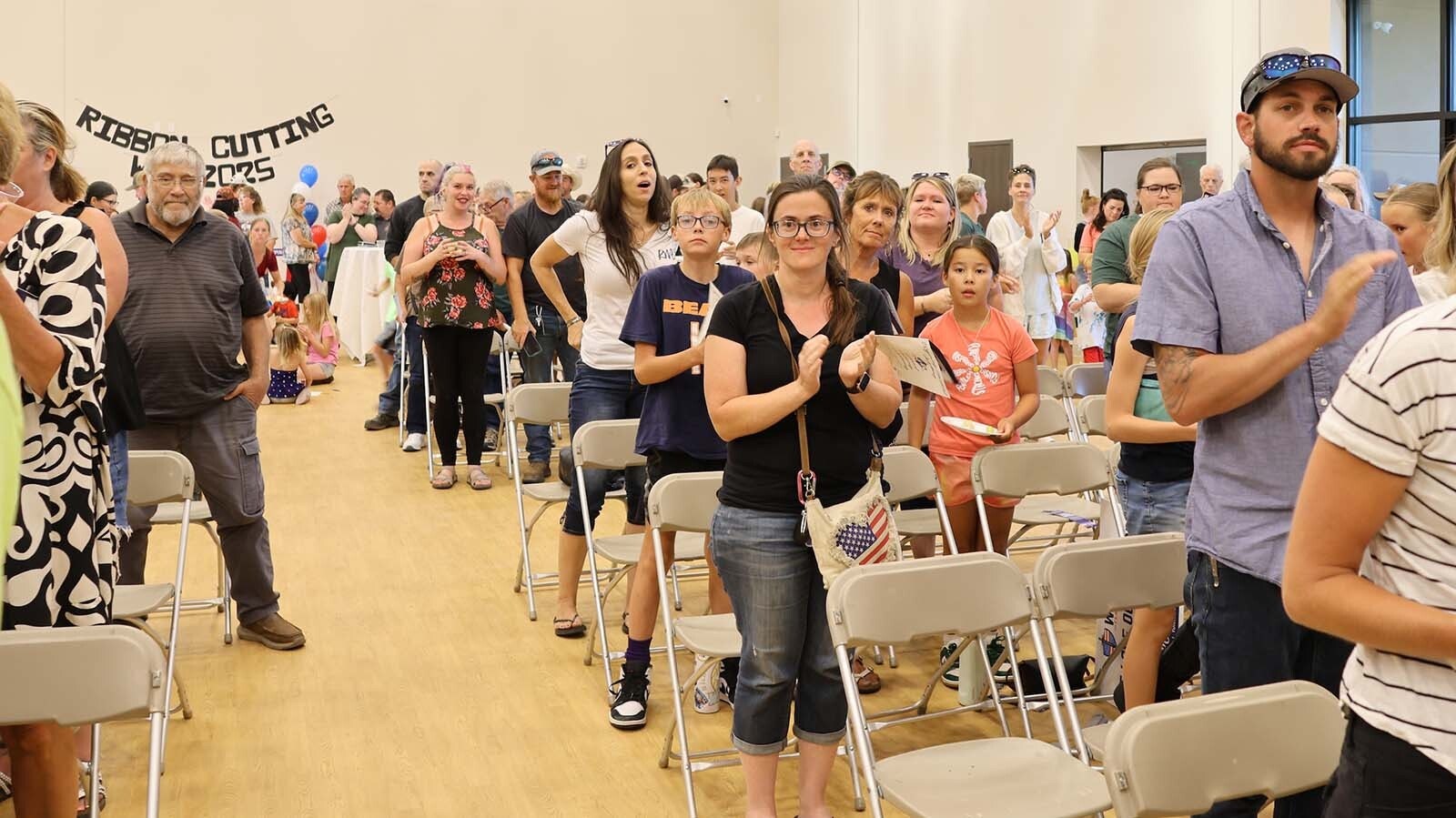 Those attending the Wyoming Classical Academy ribbon cutting ceremony applaud Russ Donley, the school’s founder and board chairman.