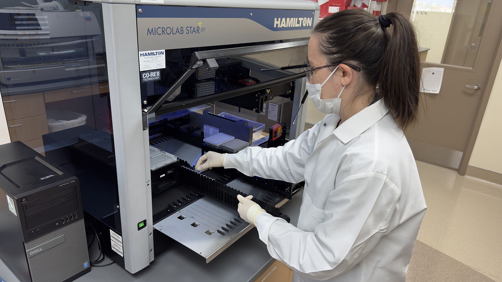 Amber Smith, a forensic analyst at the Wyoming State Crime Lab in Cheyenne, demonstrates how this Hamilton aparatus works. It can process nearly 90 individual DNA samples at a time.