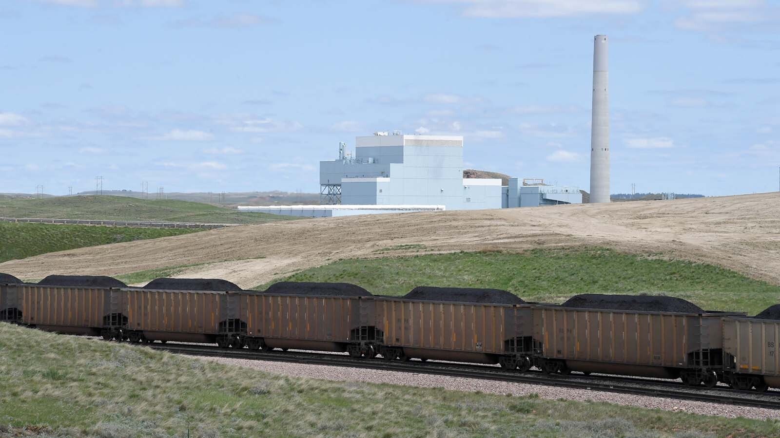 A full coal train rolls through Wyoming's Powder River Basin about 10 miles north of Gillette. The Dry Fork Station coal-fired power plant is in the background.