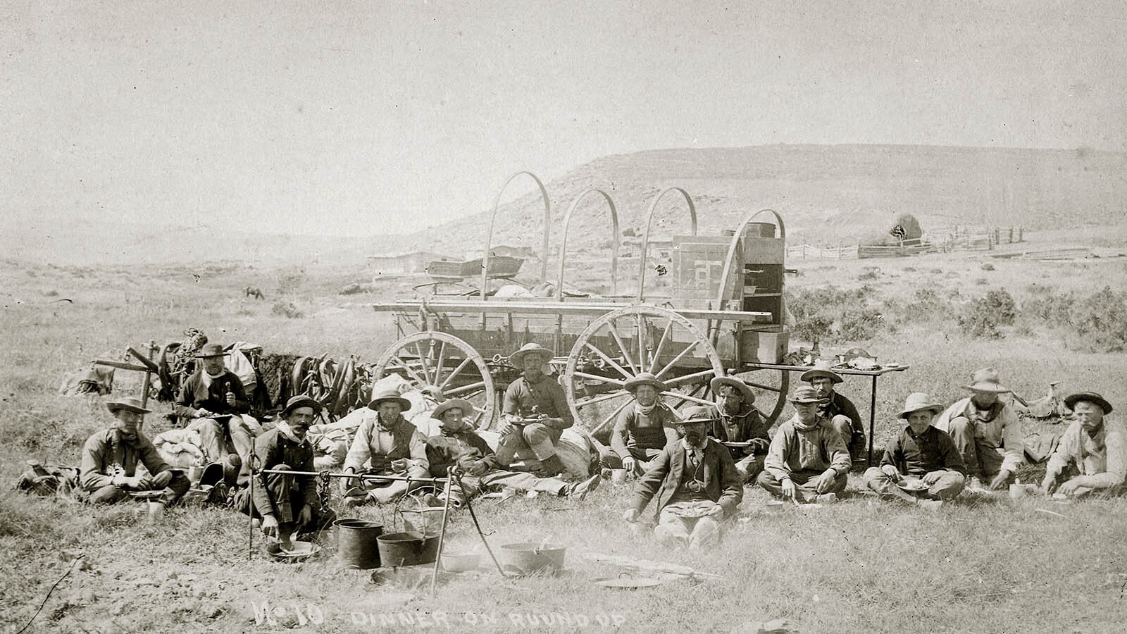 Wyoming cowboys eating a meal a chuck wagon in this undated photo.