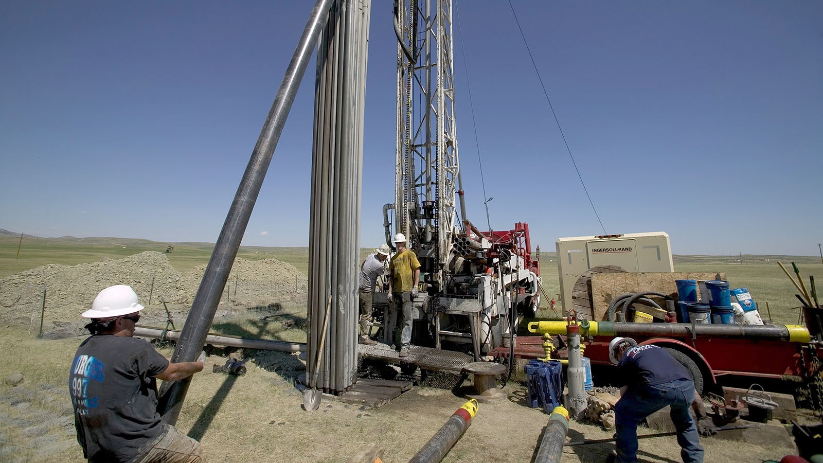 Rig workers move pipe at a coalbed methane well in the Powder River Basin south of Gillette in this file photo.