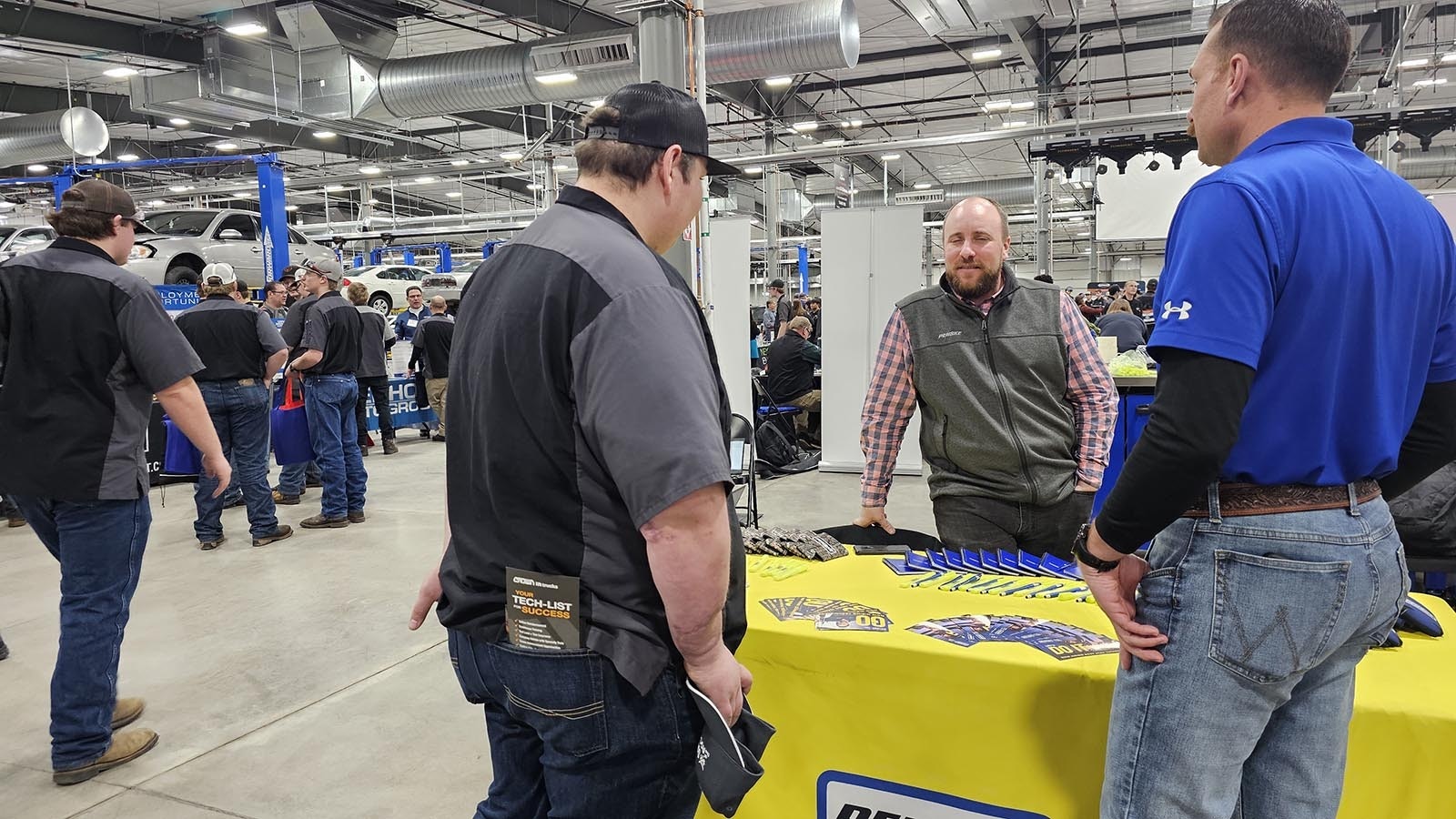 Penske representatives talk with a WyoTech student during a recent job fair at the career and technical training school.