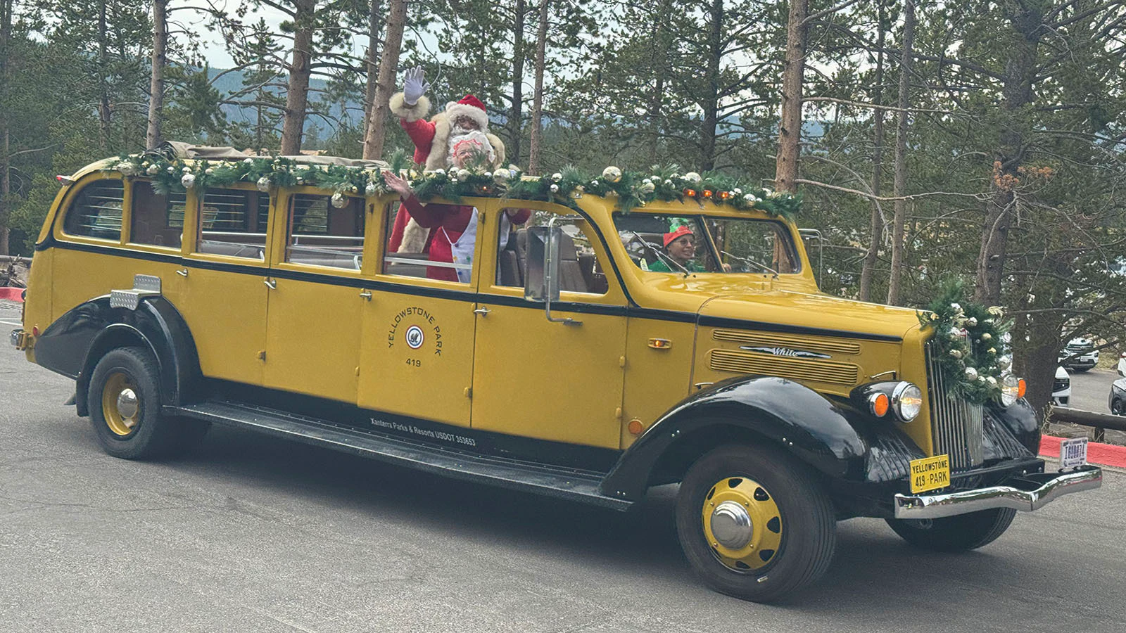 As part of an August tradition, Santa Claus arrives at the Old Faithful Inn in a 1936 White Motor Company 706 14-passenger bus.