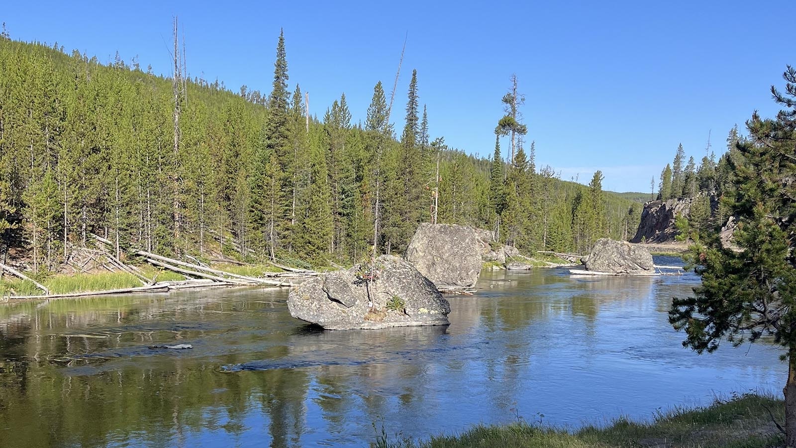 Christmas Tree Rock, two of them actually, in the middle of Firehole River decorated on Aug. 25 2024.