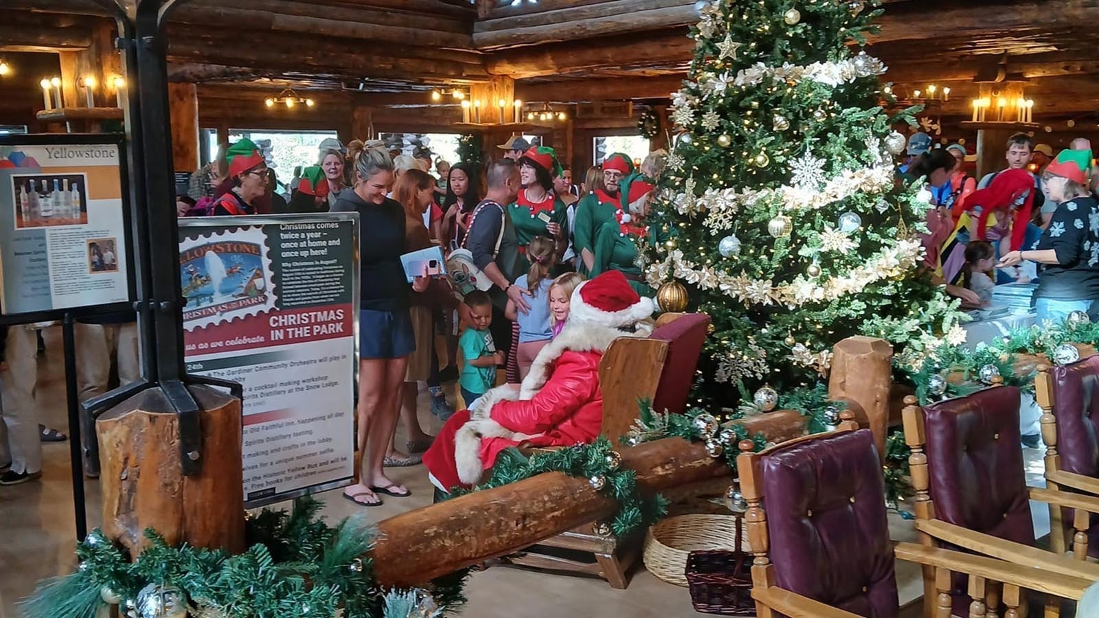 Santa hears Christmas wishes from tourists in flip flops during the annual Christmas in August in Yellowstone National Park.