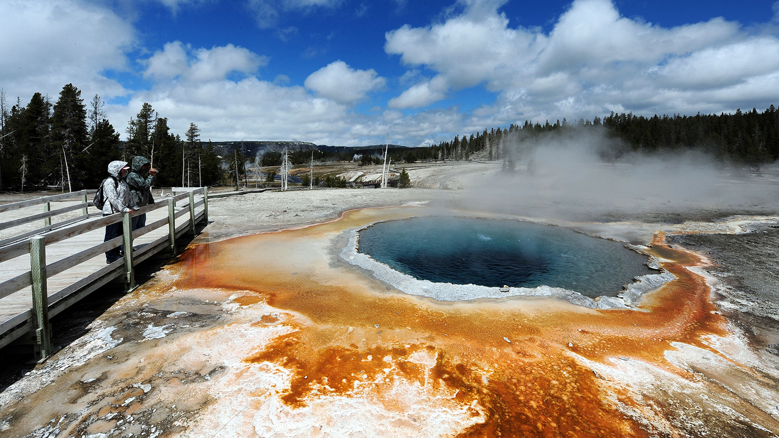 Visitors at Crested Pool in the Upper Geyser Basin of Yellowstone National Park in a file photo.
