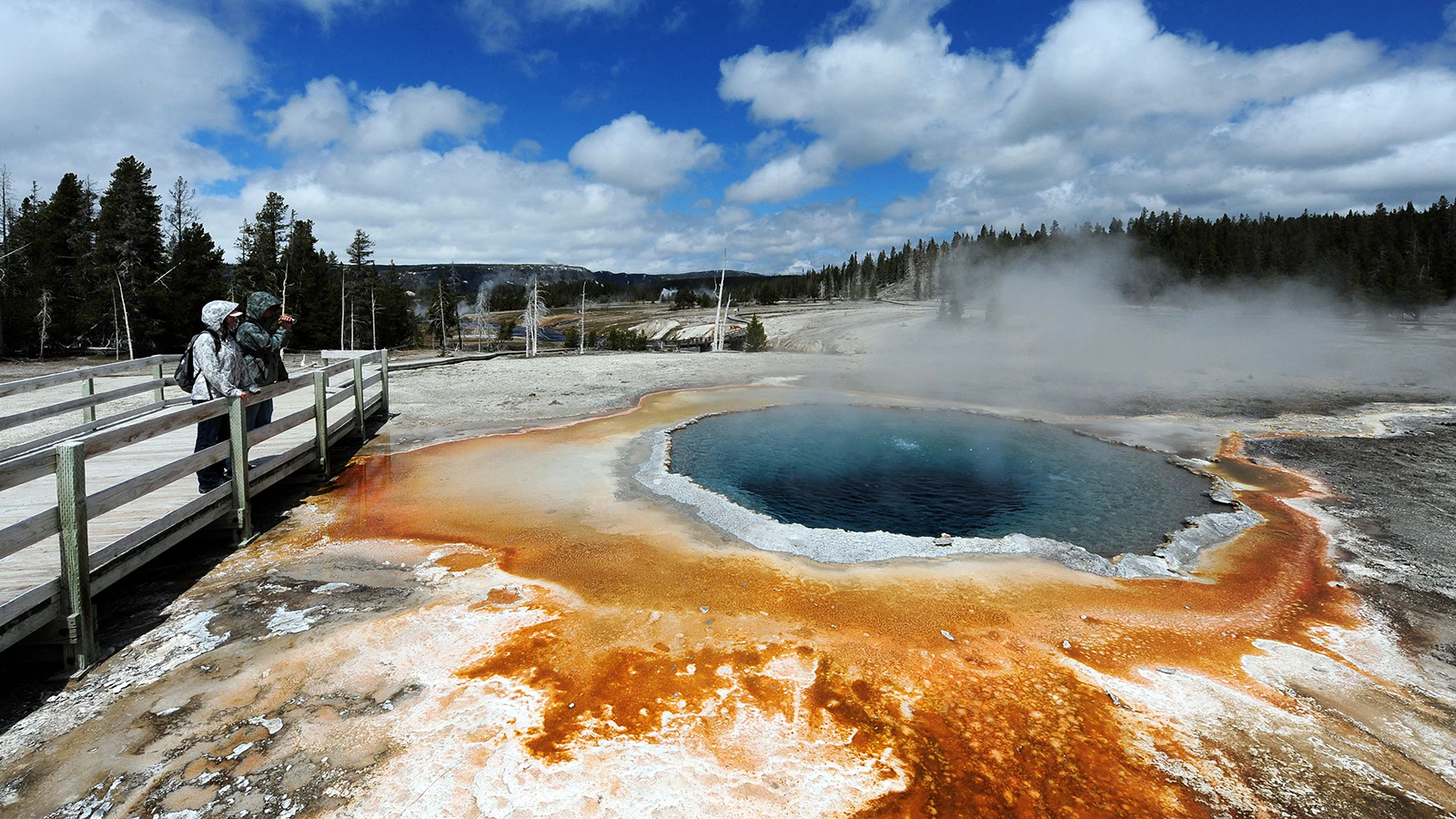 Visitors at Crested Pool in the Upper Geyser Basin of Yellowstone National Park in a file photo.