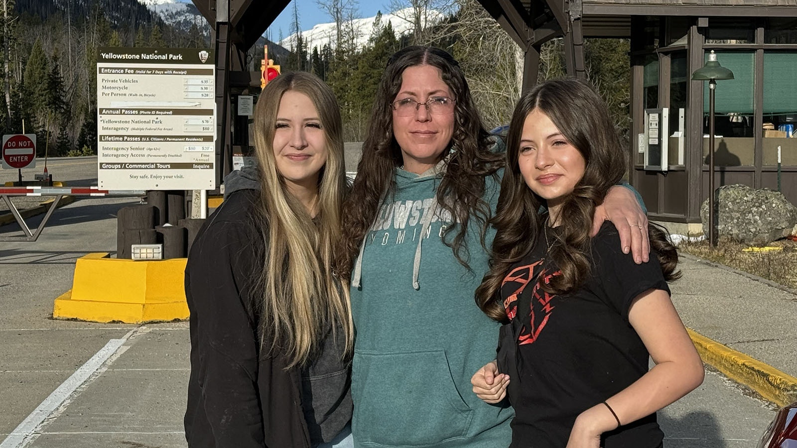 Stacy Boisseau with her daughters Hailey and Grace at the East Entrance of Yellowstone National Park the morning of its 2024 opening.
