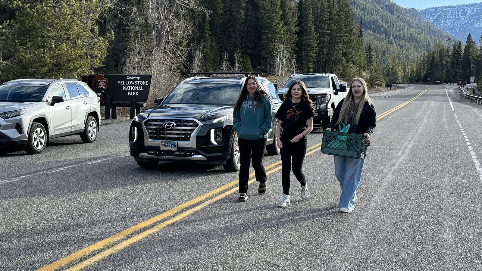 Stacy, Hailey, and Grace after handing out carrot cake to the line of vehicles waiting to go through the East Entrance of Yellowstone National Park.