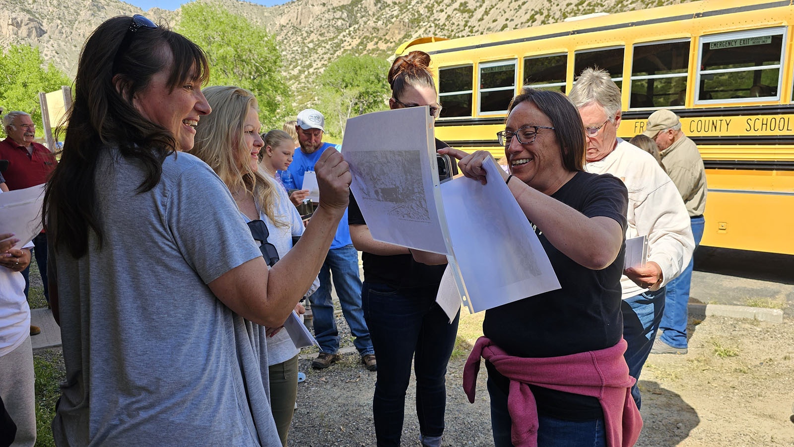 Jackie Dorothy passes out historical photos of the construction of Wind River Canyon's scenic byway 100 years ago.