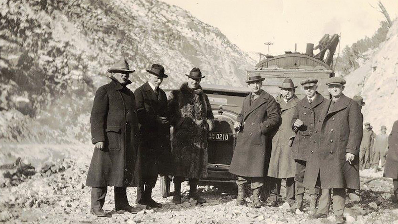 A group of men with the first cars going over the Yellowstone Highway through Wind River Canyon in 1924.