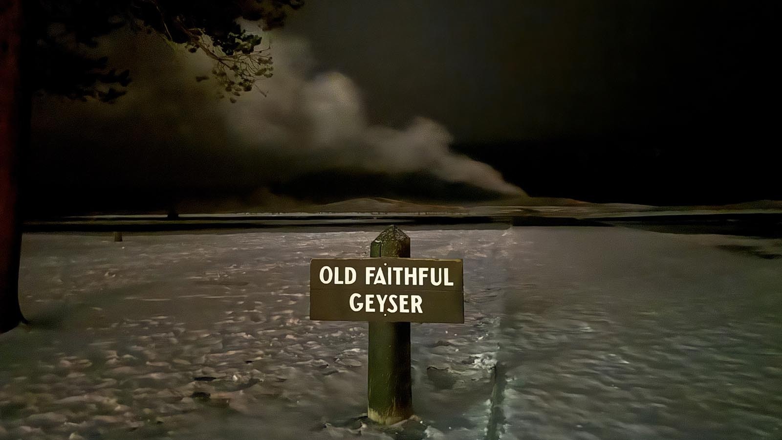 Old Faithful Geyser in Yellowstone National Park percolates under as clear night sky.