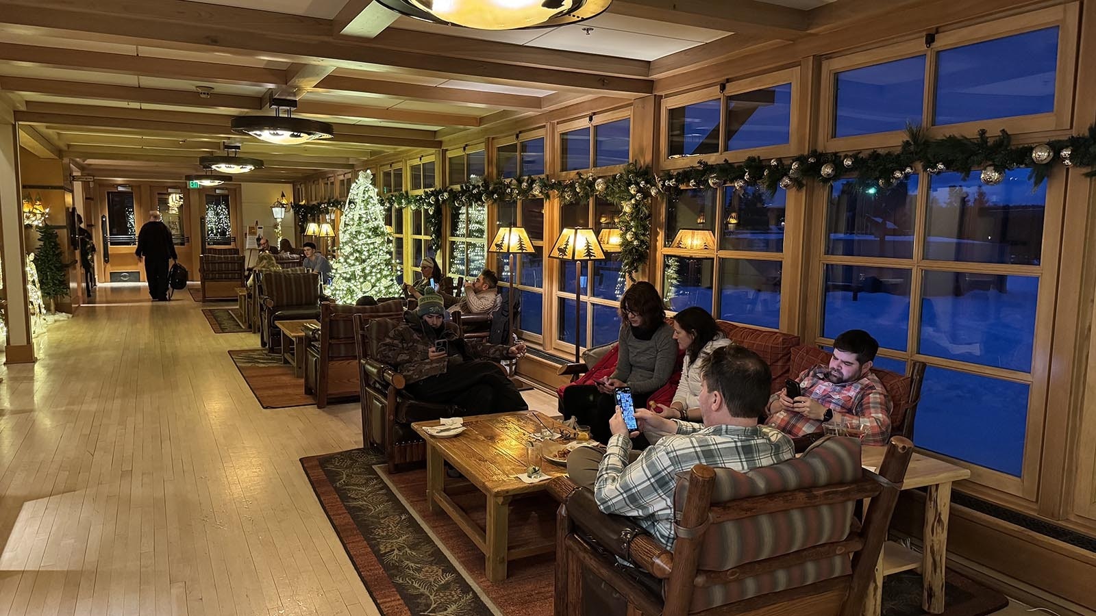 Families enjoy a holiday moment in one of the common areas of the Old Faithful Snow Lodge.