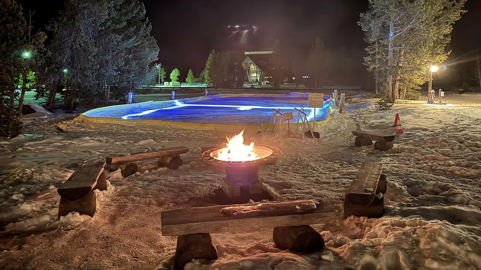 A firepit and skating rink right outside the door of the Old Faithful Snow Lodge in Yellowstone National Park.