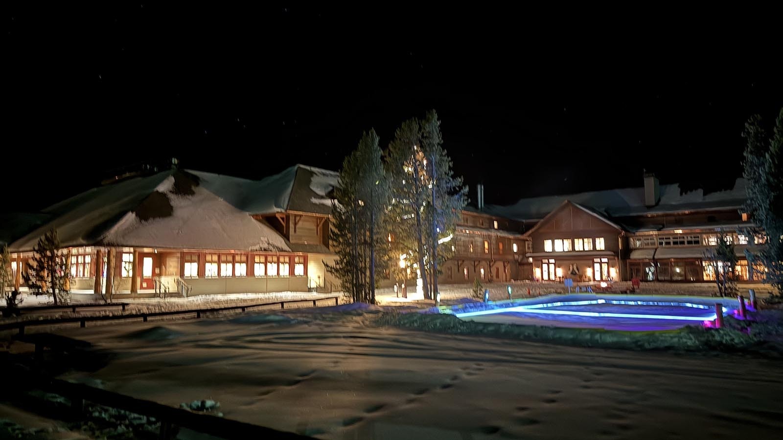 The lighted exterior of the Old Faithful Snow Lodge in Yellowstone National Park.