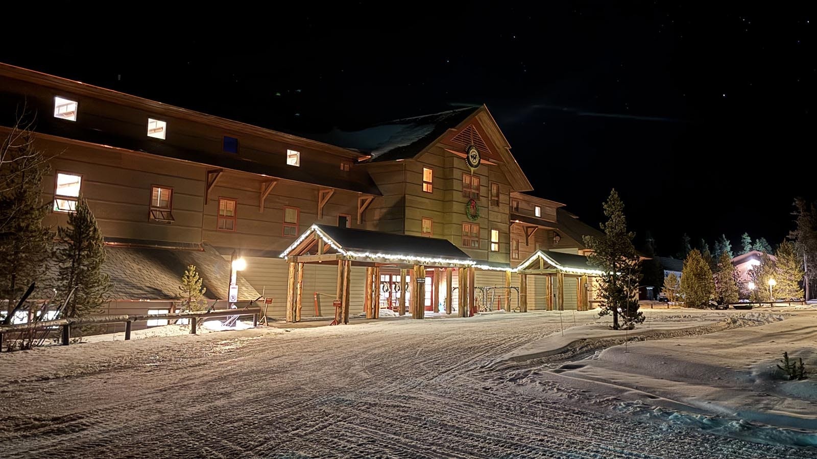 The lighted exterior of the Old Faithful Snow Lodge in Yellowstone National Park.