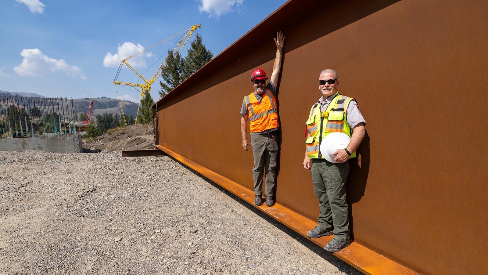 Work progresses on a massive $118 million project to replace the Yellowstone River Bridge in the national park. Here a pair of workers stand on the lip of one of the massive I-beams for the bridge.