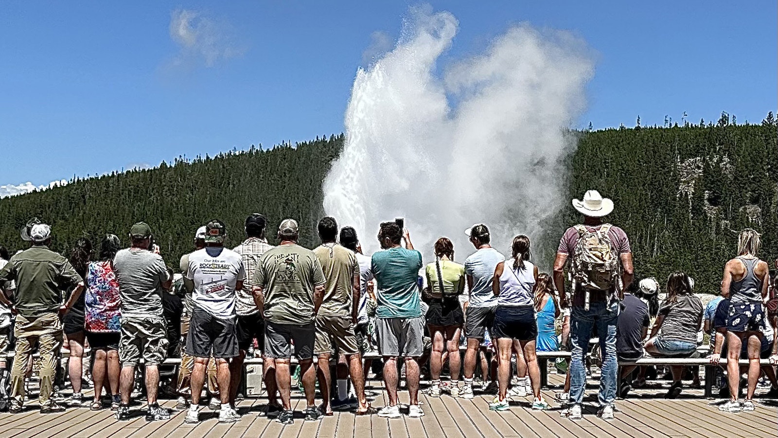 Visitors gather to watch the eruption of Old Faithful in Yellowstone National Park five days after a Kansas woman was killed by a grizzly on a West Yellowstone hiking trail.