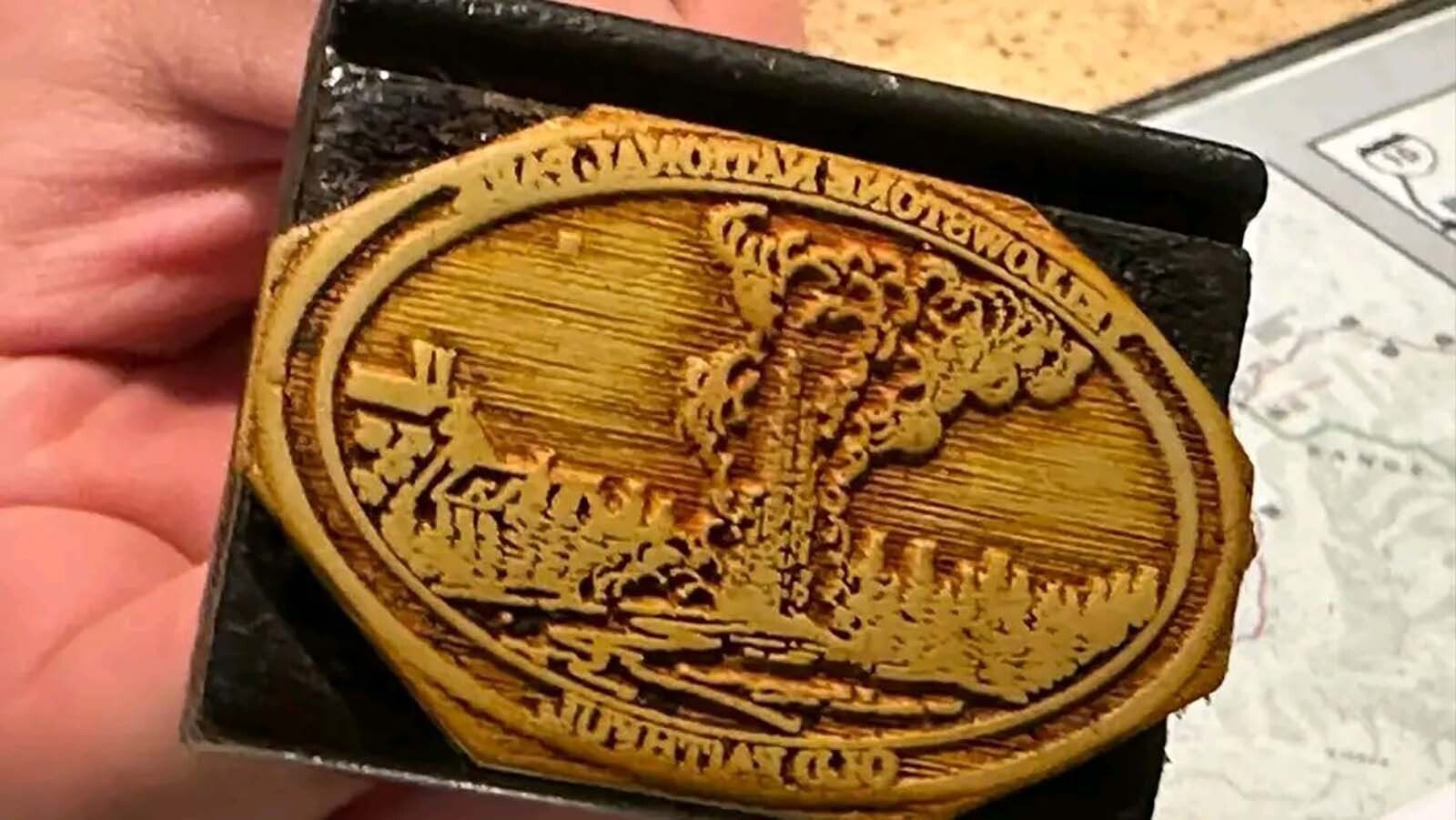 The Old Faithful stamp at the Old Faithful Visitor Center in Yellowstone National Park in 2025. There isn't much information on the history of this ornate stamp, but several Yellowstone visitors who have seen and gotten this stamp have been told it's over 90 years old and is only available upon request.