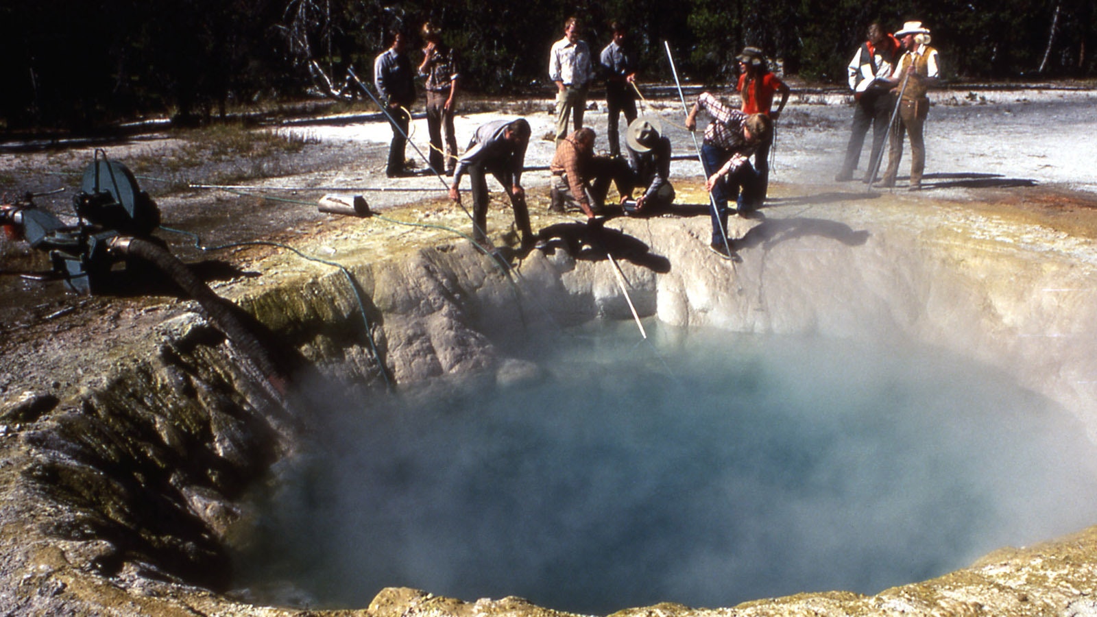 Rangers attempting to clean trash out of Morning Glory Pool in September 1975.