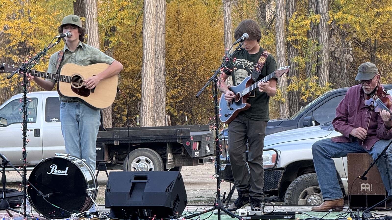 Layne, left, and Liam Jordan are joined by Tom Webb. A flatbed trailer acts as an improvised stage in Hyattville in October 2024.