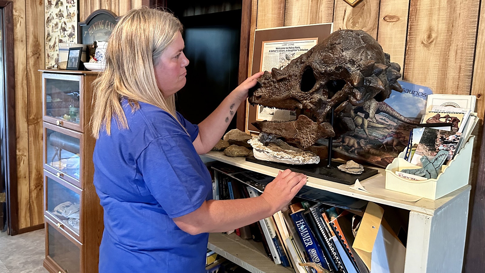 Kris Stauffer with a skull of Pachycephalosaurus. Replicas of this rare dinosaur fossil are in museums and homes, copied from the original fossils found by Kris' father, Leonard Zerbst, on the ranch.