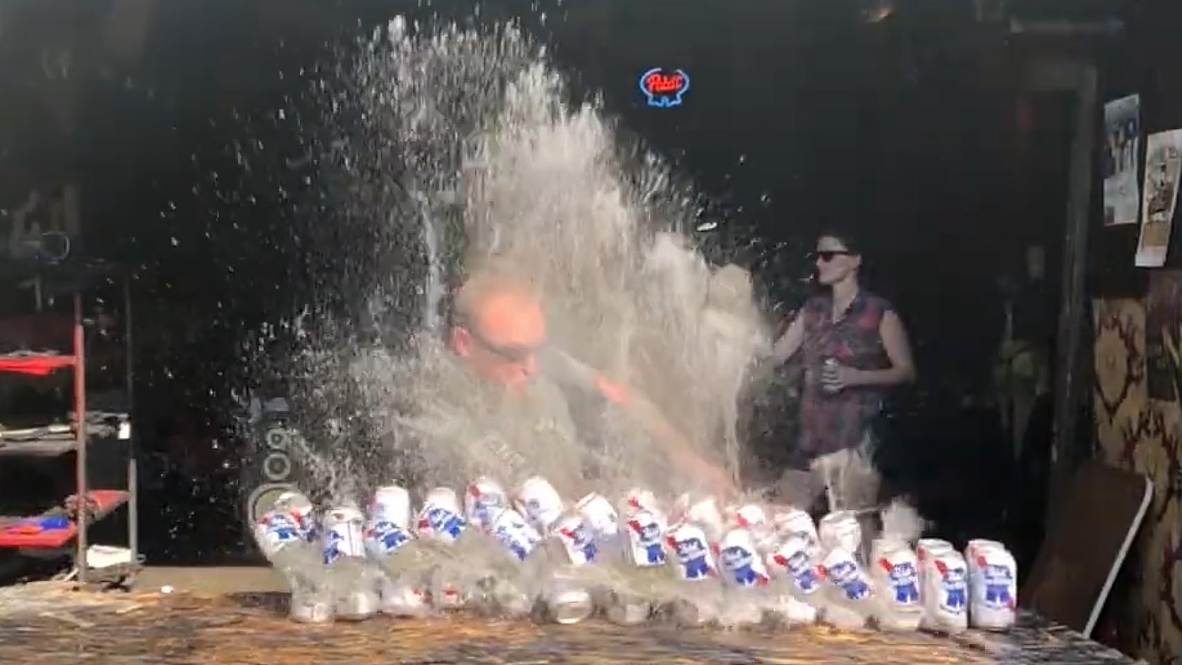 A two-handed sword slices through 29 cans of beer, demonstratiung the cutting power and range of the weapon to stave off hoards of zombies.