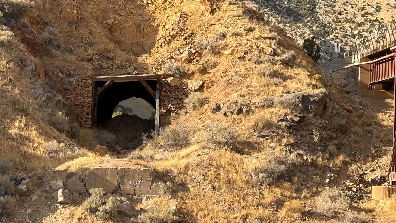 Abandoned tunnel in the Boysen State Park that the railroad refused to build higher. This resulted in decades of court battles against Asmus Boysen to demolish his dam in the Wind River Canyon. It's now crumbling.