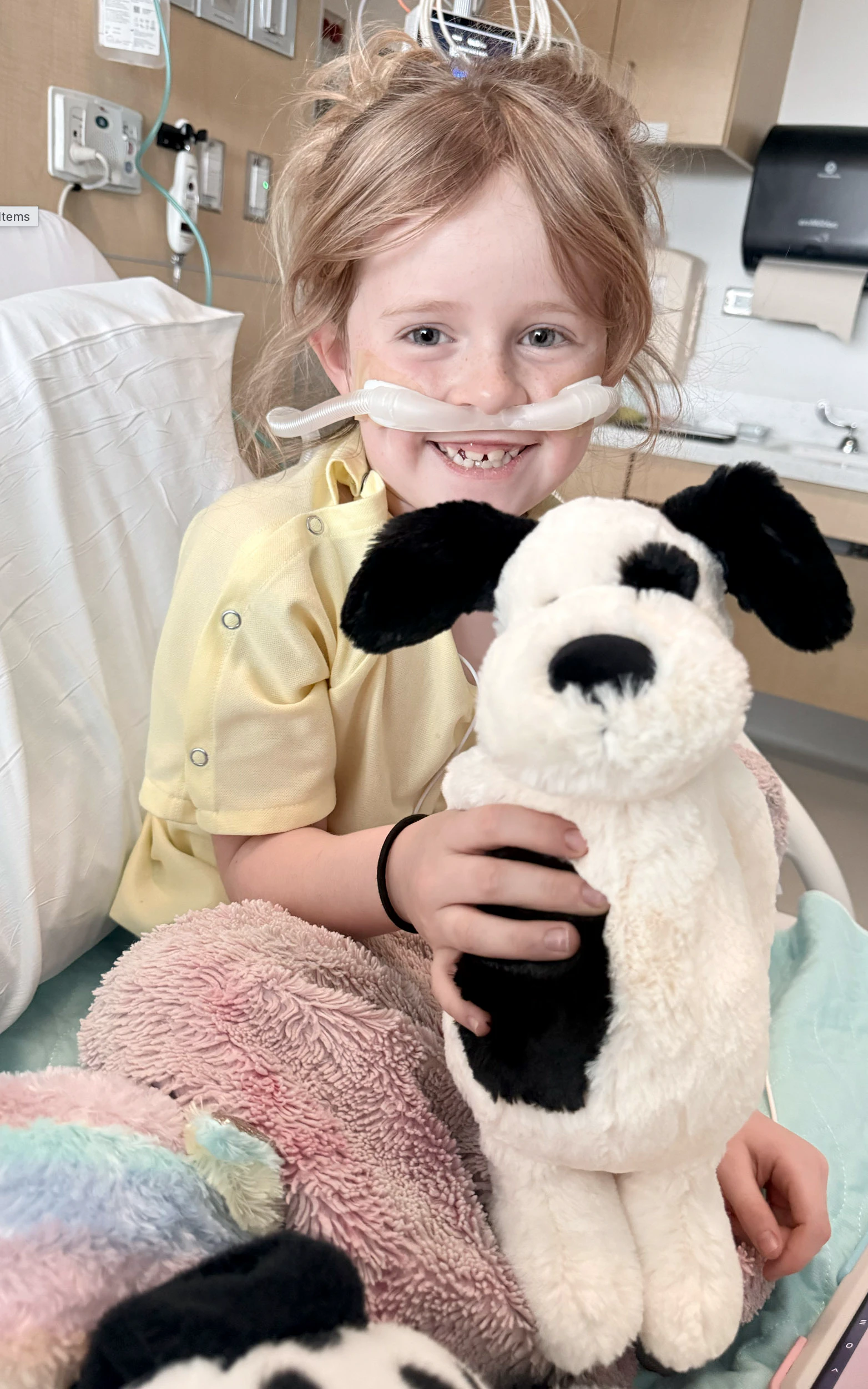 Octaveia “Tavey” Mindrum, 7, smiles with a stuffed dog while recovering at Children’s Hospital Colorado after being Life Flighted from Gillette with severe respiratory problems linked to rhinovirus.